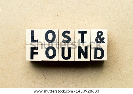 Letter block in word lost & found on wood background Royalty-Free Stock Photo #1450928633