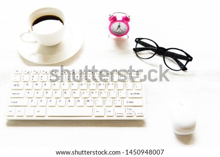 smartphone, tablet and coffee cup with financial documents on wooden table. Office stuff. Bussines coffee break concept.