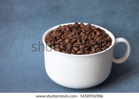 
coffee grains in a cup on a background