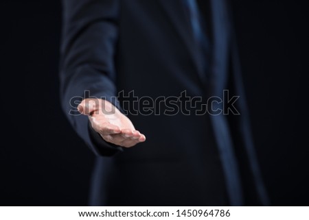 Businessman with arm out in a welcoming gesture.welcoming to cooperation and  at job interview concept.