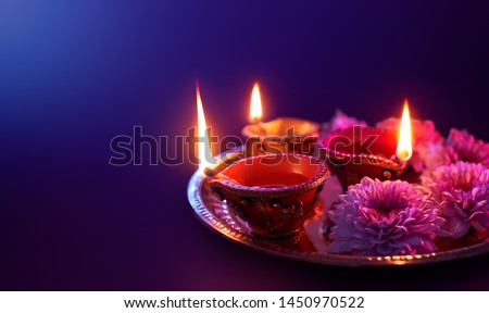 Happy Diwali - Colorful clay diya lamps lit during diwali celebration with copy space Royalty-Free Stock Photo #1450970522