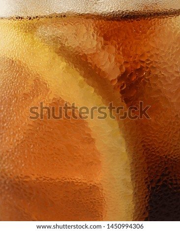 Side view background of cold cola with ice in glass, closeup