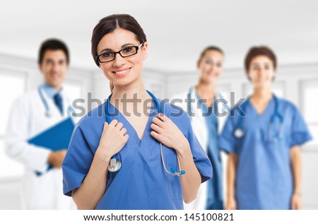 Portrait of a smiling nurse in front of her medical team
