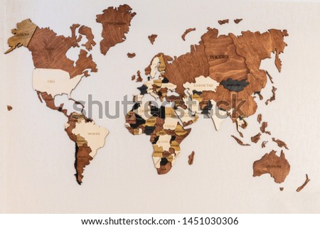 World map of earth showing continents on a wood tree ring textured background on white