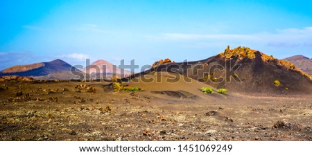 Amazing landscape of volcano craters in Timanfaya national park. Popular touristic attraction in Lanzarote island, Canary islans, Spain. Artistic picture. Beauty world.