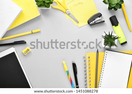 Composition with stationery and tablet computer on grey background