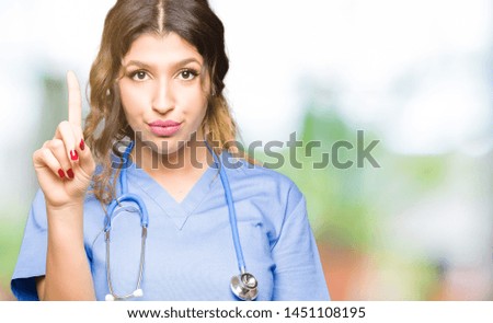 Young adult doctor woman wearing medical uniform Pointing with finger up and angry expression