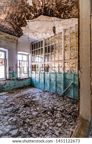 abandoned hospital light-blue colored room with lot of windows