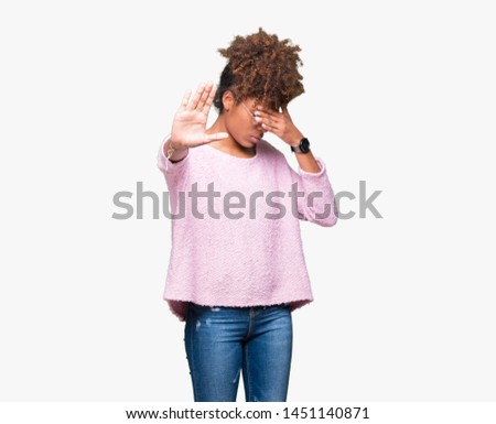 Beautiful young african american woman wearing glasses over isolated background covering eyes with hands and doing stop gesture with sad and fear expression. Embarrassed and negative concept.