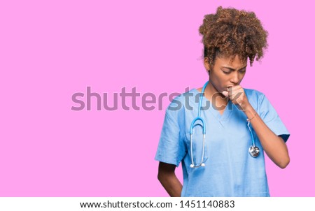 Young african american doctor woman over isolated background feeling unwell and coughing as symptom for cold or bronchitis. Healthcare concept.