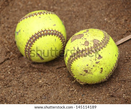 Yellow Softball on wet sand
