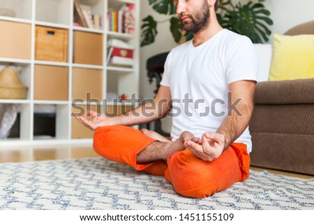 Man practicing yoga and meditation at home. A series of yoga poses. Lifestyle concept.