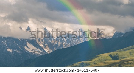 Beautiful mountains in clouds with rainbow, magic landscape panorama, nature background