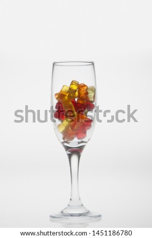 
Marmalade bears in the wineglass on white background Royalty-Free Stock Photo #1451186780