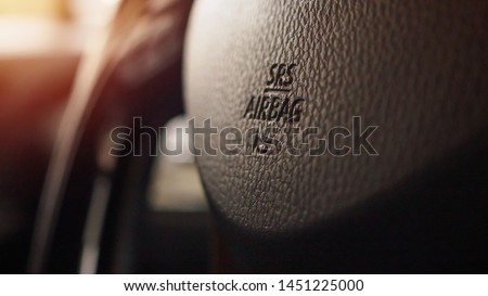 Safety airbag sign on car steering wheel with horn icon Royalty-Free Stock Photo #1451225000