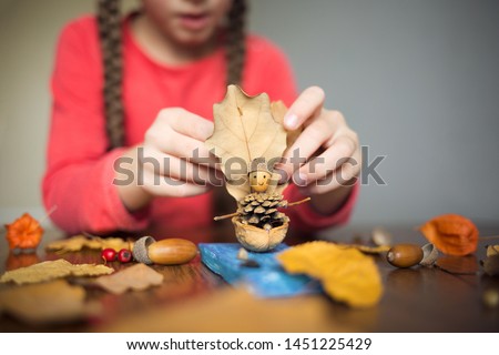 autumn craft with kids. children's cute boat with man made of natural materials. process of creating. Royalty-Free Stock Photo #1451225429