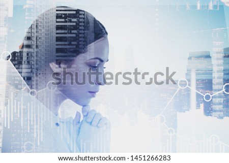 Portrait of pensive young businesswoman with dark hair with double exposure of cityscape and graphs. Concept of stock market and trading. Toned image