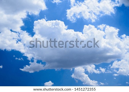 Contrasting blue sky with thick white clouds. Natural background