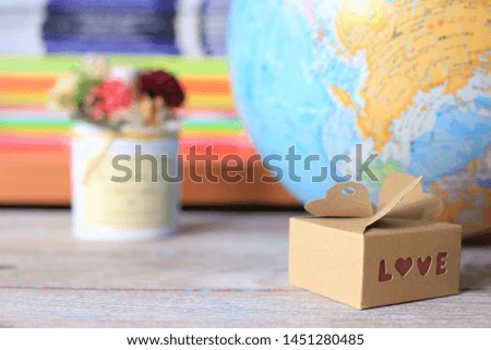 Small brown paper gift box have a love message on old wooden floors selective focus and shallow depth of field