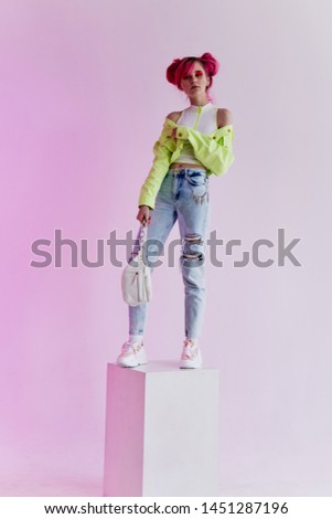 woman with standing on a cube on a light background neon fashion retro