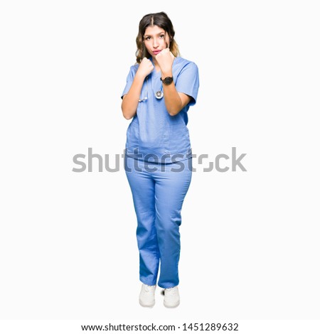Young adult doctor woman wearing medical uniform Ready to fight with fist defense gesture, angry and upset face, afraid of problem
