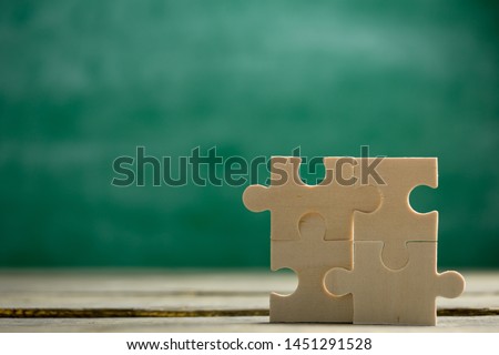 Creative solution for idea - business concept, jigsaw puzzle on the green blackboard background Royalty-Free Stock Photo #1451291528