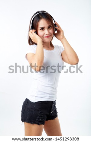 Image of a happy young beautiful woman posing headphones listening music white background