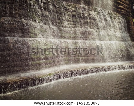 Water flows over a series of steep drops in the course of a stream.