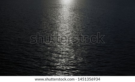 Dark sea surface. Sunlight reflecting to water.
