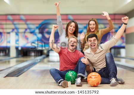 Emotional young people in bowling