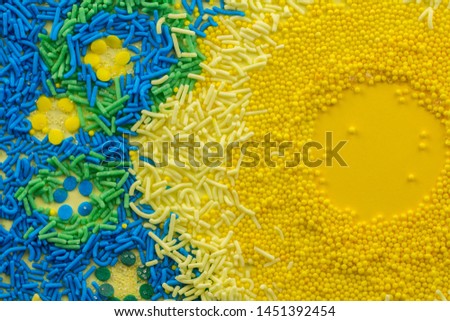 Birthday cake sprinkles on yellow background - Picture of flower shape sprinkles with space for text