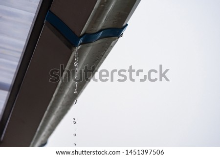 Rain storm with metal sheet roof,rainwater flows down the roof