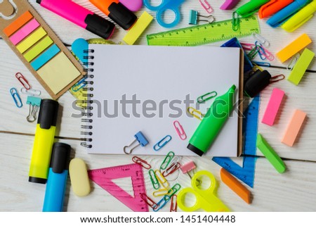 
school and office supplies on a wooden table
