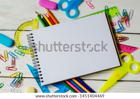 
school and office supplies on a wooden table
