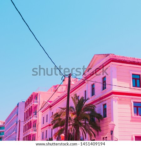 Pink hotel and palm tree in infrared style