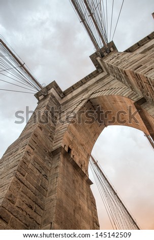 The Brooklyn Bridge, New York. Architectural detail at summer sunset.