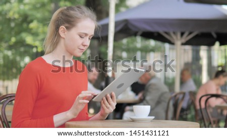 Young Woman Using Tablet, Sitting in Cafe Terrace