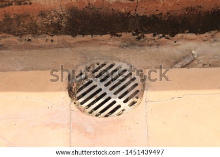 Iron grid on cement floor for stop garbage to make water flow when raining