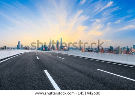 Empty asphalt highway and modern city skyline in Shanghai at sunset,China