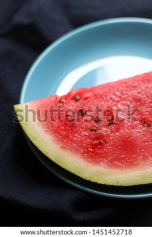 Slice of watermelon on turquoise plate. Selective focus.