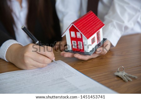 Investors signed a contract,  Buying and selling real estate. Property investment and house mortgage financial concept.