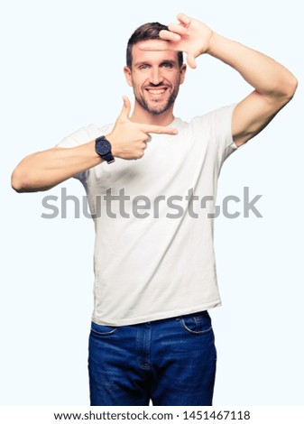 Handsome man wearing casual white t-shirt smiling making frame with hands and fingers with happy face. Creativity and photography concept.