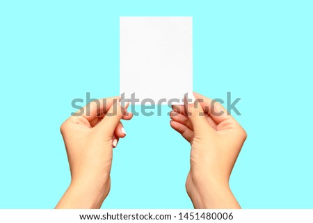 Hands holding blank paper note card