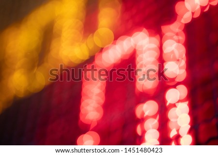 Out-of-focus effect, orange and red LED lights from the scoreboard. Suitable to be a background image. Royalty-Free Stock Photo #1451480423