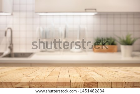 Wood table top on blur kitchen counter (room)background.For montage product display or design key visual layout. Royalty-Free Stock Photo #1451482634