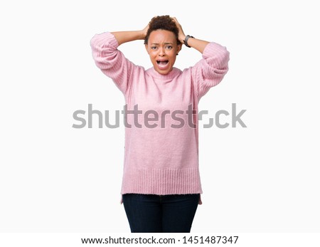 Beautiful young african american woman over isolated background Crazy and scared with hands on head, afraid and surprised of shock with open mouth