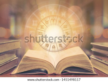 Horoscope astrology, Zodiac sign and constellation study for foretell and fortune telling education course concept with horoscopic wheel over old book in school library Royalty-Free Stock Photo #1451498117