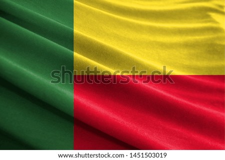 Realistic flag of Benin on the wavy surface of fabric