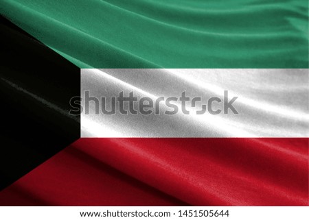 Realistic flag of Kuwait on the wavy surface of fabric