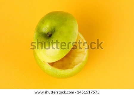 Healthy Green Cut Apple floating top slice juice drink idea concept on yellow background 